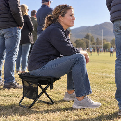 Sitting on the Lumeo Sling Stool at a rugby touchline